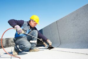 Man laying down commercial roof